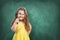 Little curious school girl with magnifier on chalkboard