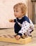 Little curly boy holds a chess-board