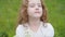 Little curly girl gives a bouquet to mother or father