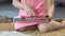 Little curly girl sitting on the carpet and scrolling on tablet, educational app