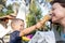 Little cute adorable playful caucasian blond toddler boy kid sharing sweet tasty ice cream with mom on hot summer day