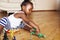 Little cute african american girl playing with animal toys at home, pretty adorable princess in interior happy smiling