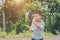 Little cute asian boy drink water on the roadside.