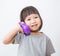 Little cute asian girl talking with the plastic phone.