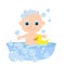 Little cute baby bathes in a bathtub with soap bubbles and a yellow rubber duck.