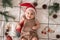 Little cute baby girl portreit in red christmas santa hat with lights top view. Christmas holidays