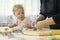 Little cute baby and grandma cooking on kitchen, child in flour teaching to bake