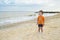 A little cute baby plays on the beach. Baby on the beach near the sea in summer