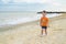 A little cute baby plays on the beach. Baby on the beach near the sea in summer