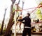 Little cute blond boy hanging on playground outside, father training with fun, lifestyle children concept