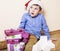 Little cute boy with Christmas gifts at home