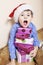 Little cute boy with Christmas gifts at home