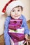 Little cute boy with Christmas gifts at home