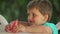 Little cute boy eats juicy watermelon with fun