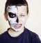 little cute boy with face paint like skeleton to celebrate hallo