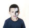 Little cute boy with face paint like skeleton to celebrate halloween, lifestyle people concept