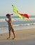 Little cute boy with kite playing on seacoast