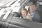 Little cute boy posing with father in car cabin.