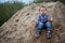 Little cute boy riding a roller coaster of sand on the bottom. Memories childhood and carefree