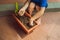 Little cute boy sows seeds in a flower pot in the garden