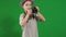 Little cute boy wearing hat takes photo at chroma key background