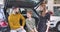 Little cute Caucasian boy with curly hair talking to his parents in car dealership. Happy smiling family choosing