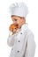 Little cute chef cooker eating delicious fresh raisin bun, isolated on white