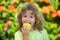 Little cute child eating green apple. Portrait of kid eating and biting an apple. Enjoy eating moment. Healthy food and