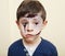 little cute child with facepaint on birthday party, zombie Apocalypse facepainting, halloween preparing concept