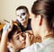 Little cute child making facepaint on birthday party, zombie Apocalypse facepainting, halloween preparing