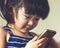 A little cute child playing cell phone device