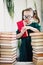 Little cute expert in books. Young librarian girl hold library book