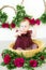 Little cute girl 1 year old in a dress of Marsala color with a wicker basket with peonies. Spring and flowers.