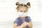 Little cute girl 4 years old wearing a disposable hygienic face mask to protective spread the disease on light background