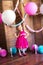 Little cute girl with blond hair in a pink dress and a princess crown with large bright balloons and garlands. Children`s holiday.