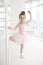 Little cute girl in class in ballet studio