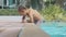 Little cute girl climbs out of the swimming pool, in slow motion.