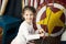 Little cute girl climbs rope ladder on background of circus scenery. World circus day. New year concept