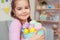 Little cute girl easter celebration at home concept holding bucket with eggs