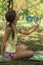 Little cute girl holding camera in hand and take a picture with selfie shot in park. beautiful eight-year-old girl in the park doi