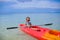 Little cute girl kayaking in the clear blue sea