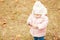 Little cute girl kid having fun in park in autumn warm clothes (