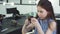 Little cute girl looking sad examining her damaged hair with split ends