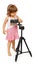 A little cute girl making making a shot with camera on tripod