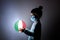 Little cute girl in medical mask holding a luminous planet Earth in her hands. Coronavirus in Italy. covid-19 concept