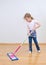 Little cute girl mopping floor.