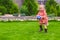 Little cute girl playing ball in the yard