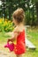 Little cute girl playing with plant watering can