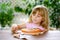 Little cute girl playing with wooden toy pizza. Preschool child having fun with children activity like, play with food