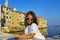 Little cute girl  posing on the embankment of Rovinj town, Croatia.